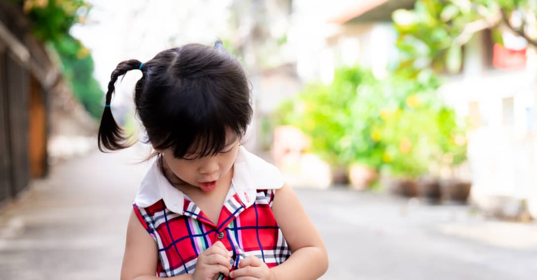 Child buttoning shirt