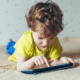 young boy playing with tablet